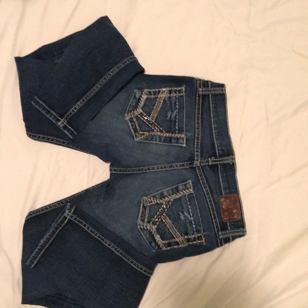 BKE  jeans with embellished pockets and stitching.